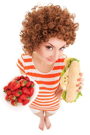 Fun woman with strawberry and sandwich on the white backgroundの写真素材