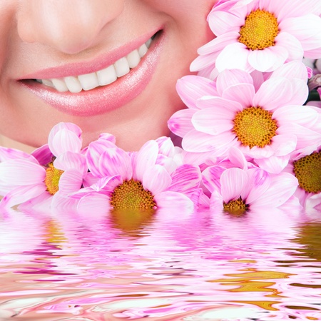 Smile of young woman with flowersの写真素材