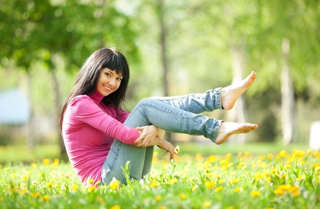 Cute woman in the park with dandelionsの写真素材