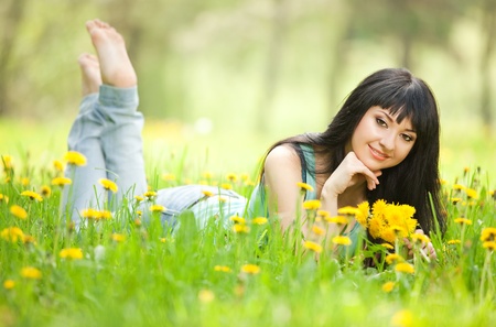Young woman in the park with flowersの写真素材