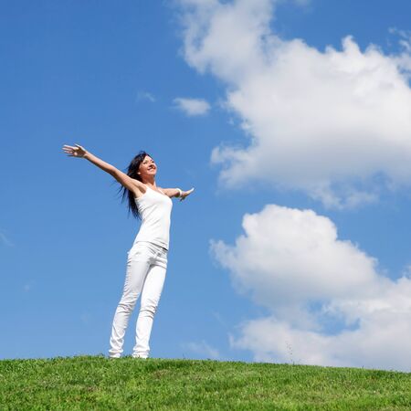 happy young woman dreams to fly on windsの写真素材