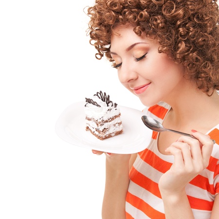fun woman eating the cake on the white backgroundの写真素材