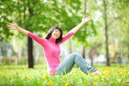 Cute woman in the park with dandelionsの写真素材