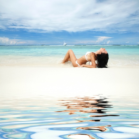 Happy young woman rest on the beachの写真素材