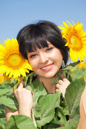 fun woman in the field of sunflowersの写真素材