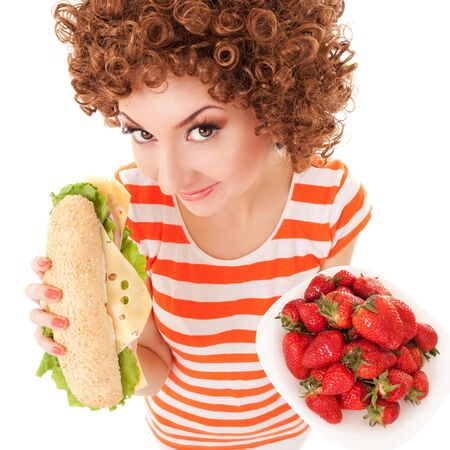 Fun woman with strawberry and sandwich on the white backgroundの写真素材