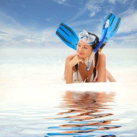 Happy woman with snorkeling equipment on the beachの写真素材