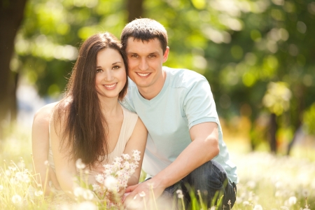 Young happy couple in the parkの写真素材