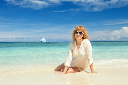 Happy young woman rest on the beachの写真素材