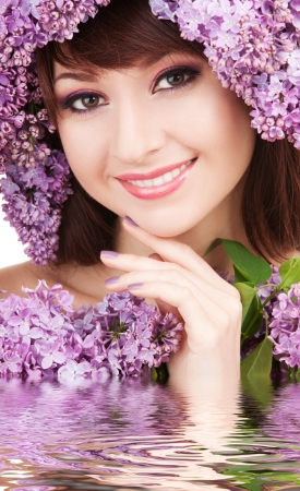 Young woman with lilac flowersの写真素材