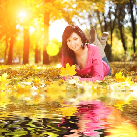 Young pretty woman rest in the autumn park の写真素材