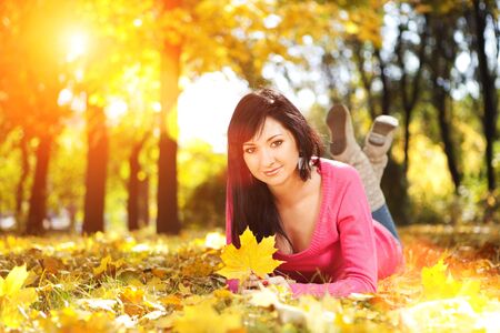 Young pretty woman rest in the autumn park の写真素材