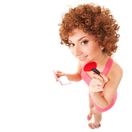 Fun woman with brush for makeup on the white backgroundの写真素材