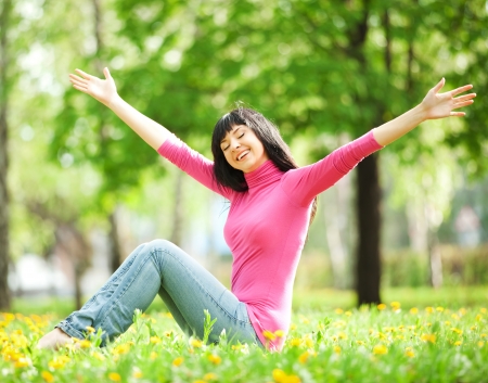 Cute woman in the park with dandelionsの写真素材