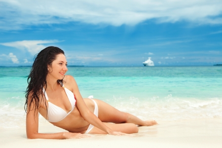 Happy young woman rest on the beachの写真素材