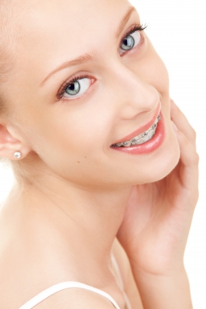 Cute girl in braces on white backgroundの写真素材