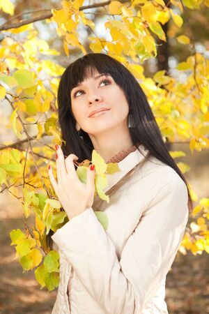 Young pretty woman in the autumn parkの写真素材
