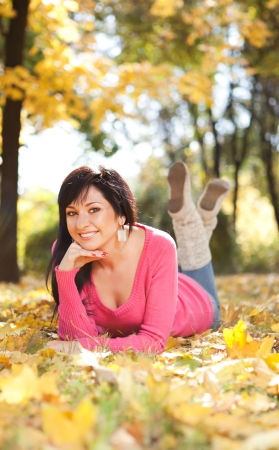 Young pretty woman resting in the autumn parkの写真素材