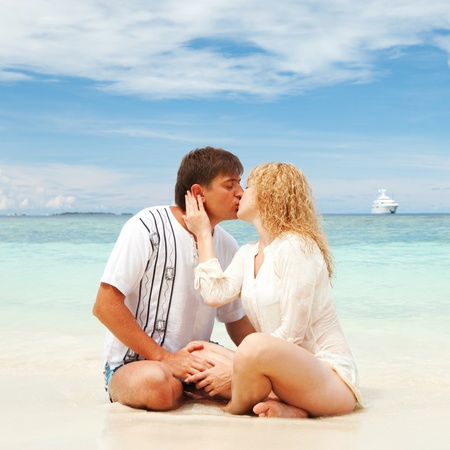 Young couple on the beach of seaの写真素材