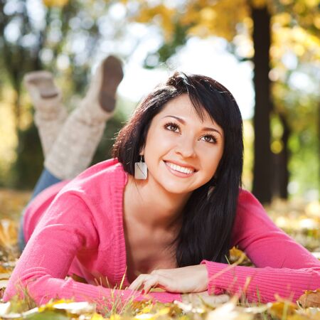 Young pretty woman rest in the autumn parkの写真素材