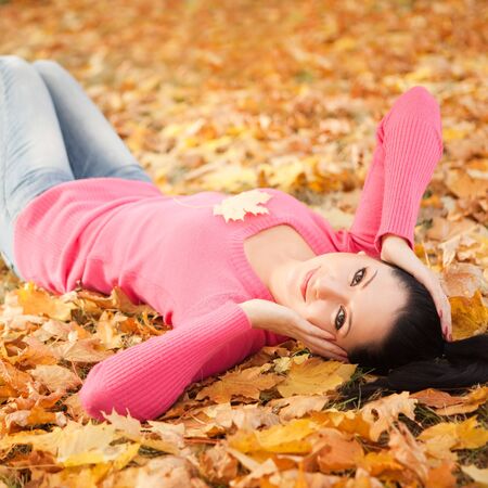 Young pretty woman relax in the autumn parkの写真素材