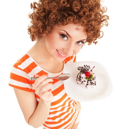 fun woman eating the cake on the white backgroundの写真素材