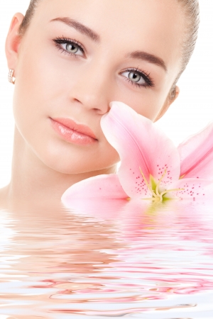 Portrait of a young beautiful woman with flowerの写真素材