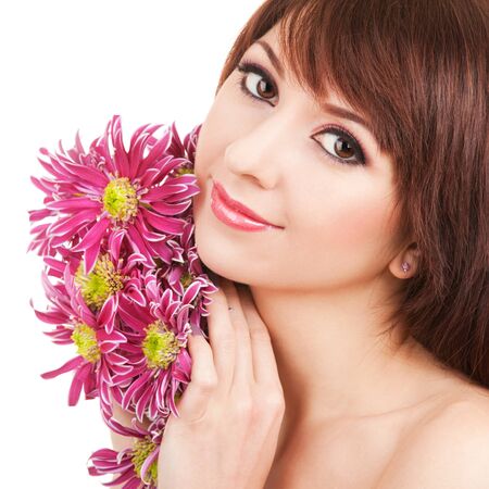 Portrait of a young beautiful woman with flowersの写真素材