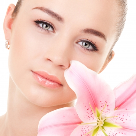 Portrait of a young beautiful woman with flowerの写真素材