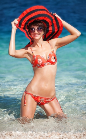 Happy fashion woman on the beachの写真素材