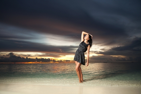 Fashion woman on the sea sunset backgroundの写真素材