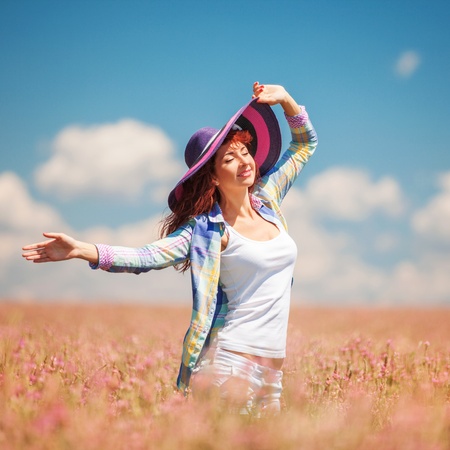 Cute woman in the field with flowersの写真素材
