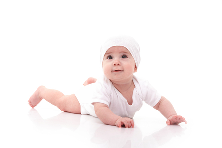 Cute baby isolated on white background. Happy childhood. Close up portrait of happy baby. Fun kid in white pajama on whiteの写真素材