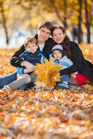 Happy family in the autumn parkの写真素材