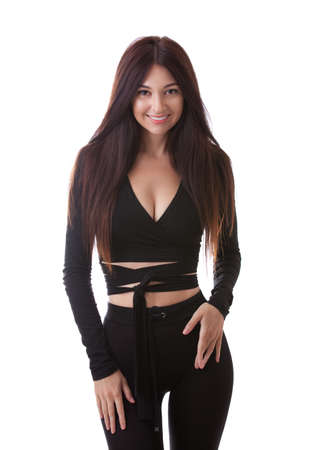 Pretty woman in black suit isolated on white background with copy space. Close up of sporty and beautiful female body. Tanned brunette with long hair. Healthy lifestyle, dieting, fitness, weight lossの写真素材
