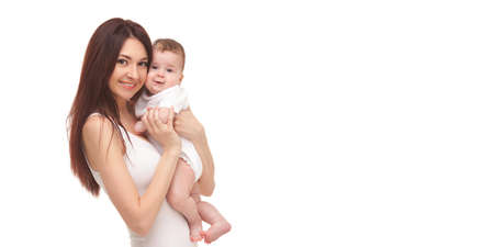 Portrait of mother and her little child in white. Happy family concept. Mother holding cute baby isolated on white background. . Motherhood and children concept. Close upの写真素材