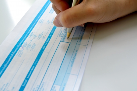 business people writing the pen on deposit slip