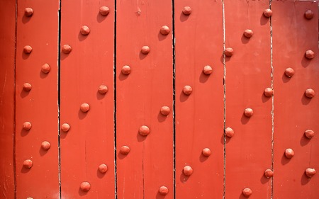 old Wooden door, reinforced with metallic bolts.の写真素材