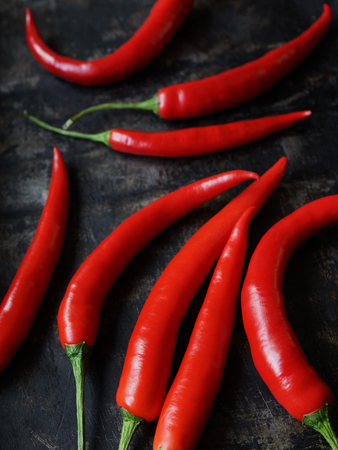 Red hot chili pepper on old oven-tray, dark backgroundの写真素材