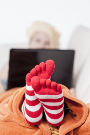 woman in warm toe socks and blanket at homeの写真素材