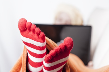 woman in warm toe socks and blanket at homeの写真素材