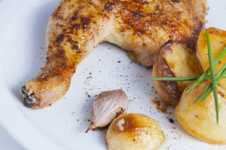 crispy chicken leg with baked potatosの写真素材