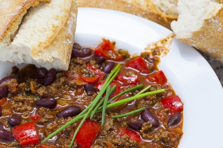 delicious home made chili con carne with bread and sour creamの写真素材