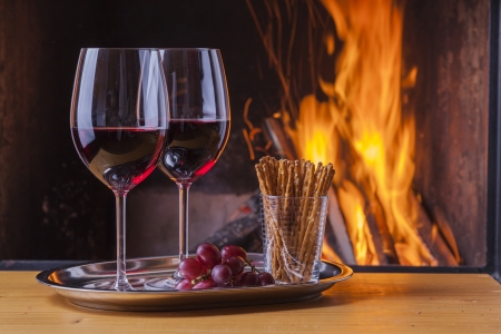 delicious drinks and snack at cozy fireplaceの写真素材