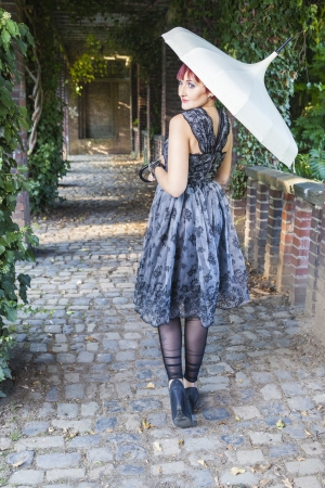 beautiful young women in vintage dress at fall, spring or autumn eveningの写真素材
