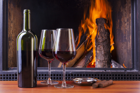 relaxing drinks at cozy warm fireplace in winterの写真素材