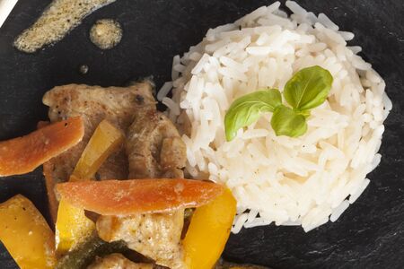 healthy fresh home made asian chicken rice dish on black slate plateの写真素材