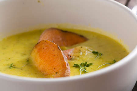 curry sweet potato soup with shrimp on vintage tableの写真素材