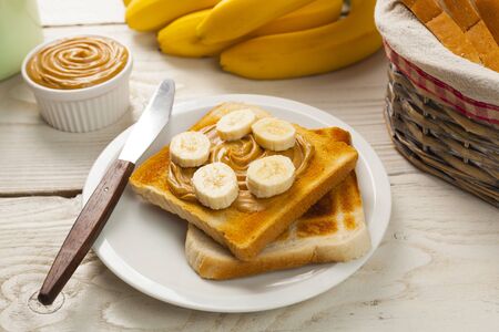 outdoor spring breakfast sweet bread spread on wooden tableの写真素材