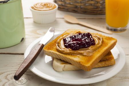 outdoor spring breakfast sweet bread spread on wooden tableの写真素材